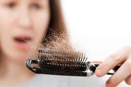 Women holding a brush containing a large amount of hair