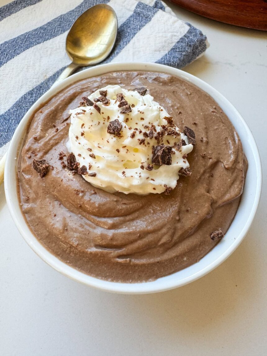 A small white bowl with chocolate pudding. There