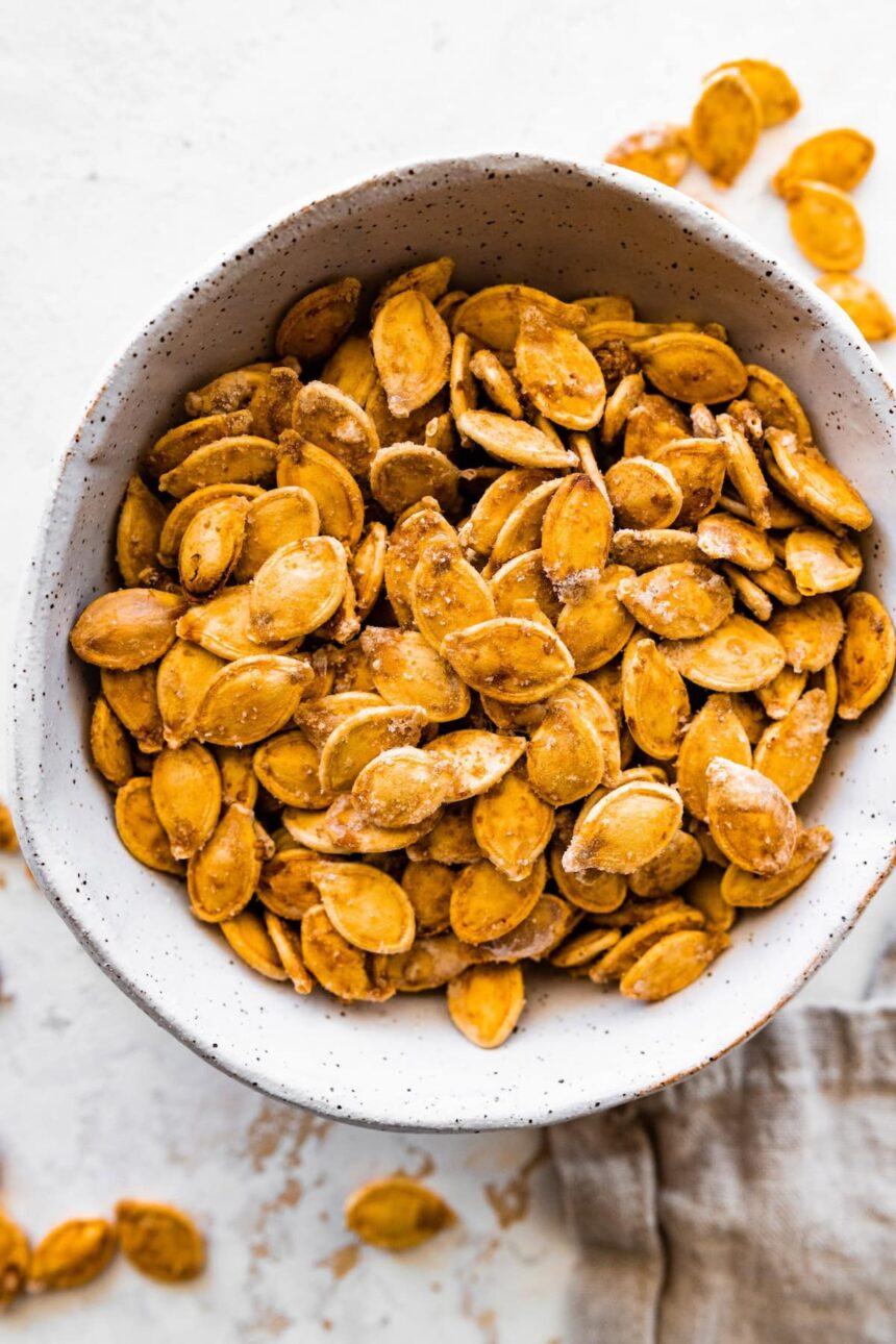 A bowl of roasted and salted pumpkin seeds.