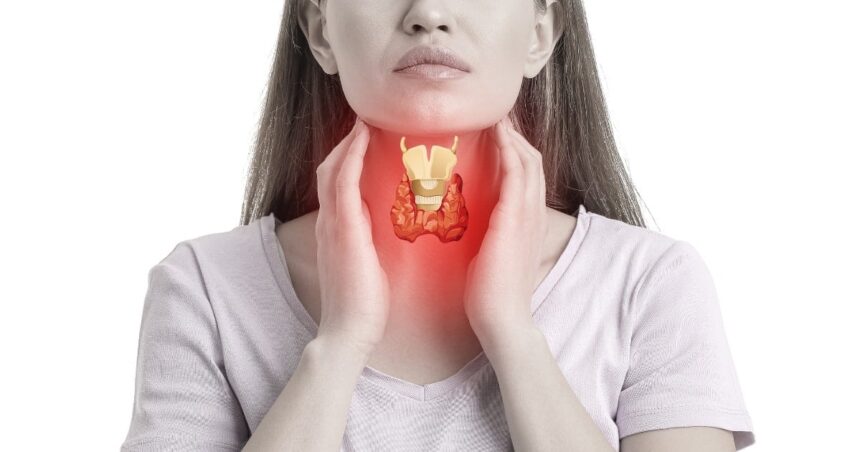 Woman holding her throat and showing  where her thyroid is