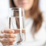 Woman holding a glass of water