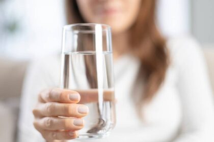 Woman holding a glass of water