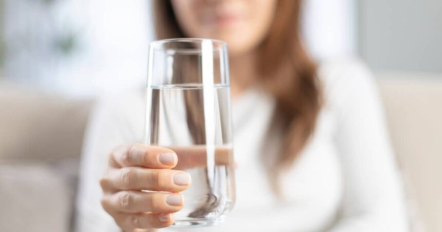 Woman holding a glass of water