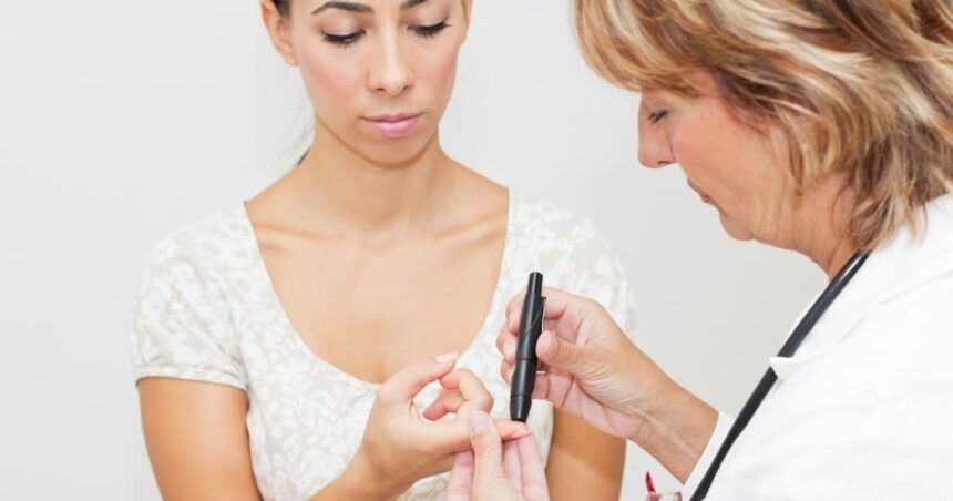 Doctor testing patient for diabetes with a fingerstick test