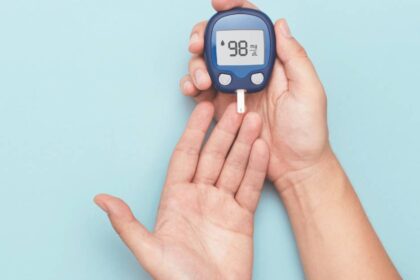 Close up of hands using a blood sugar monitor