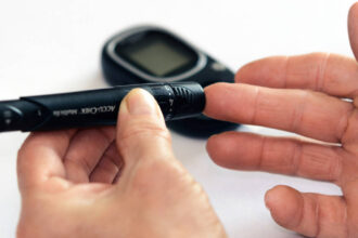 Hands testing blood sugar with a glucometer