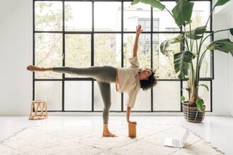 Been Feeling Weighed Down? Here’s How To Reach for the Stars With Yoga’s Half Moon Pose