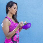 Woman eating carbs from purple bowl