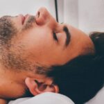 Face of man sleeping with sleep apnea