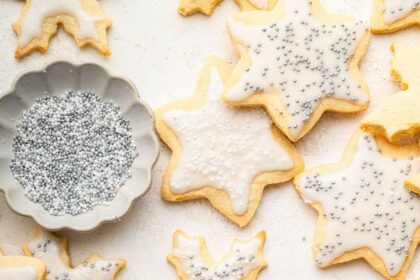 Multiple gluten free sugar cookies decorated with icing and sprinkles.