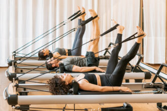 Debating Between Reformer and Mat Pilates? Here’s How To Tell Which Is Right for You